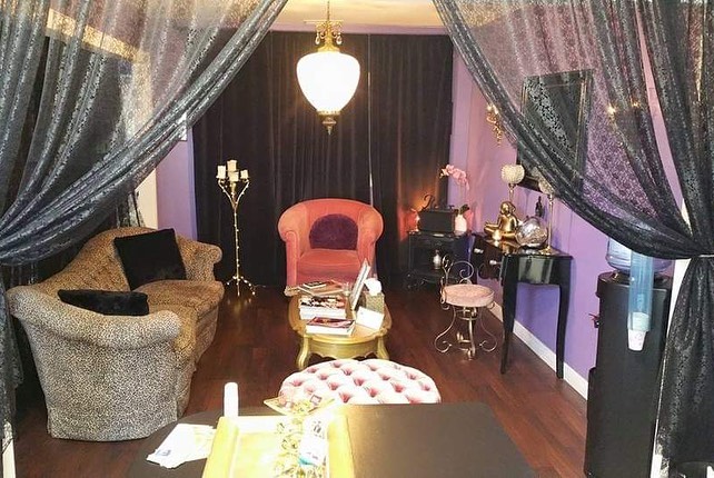Wax Queen waiting lounge with antique chair and curtains